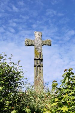 Stone cross under blue sky during daytime