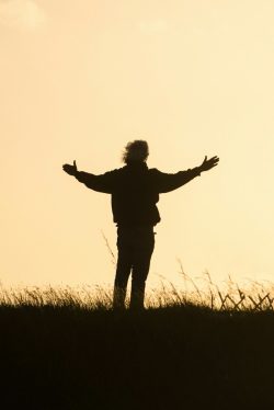 silhouette of person spreading hands